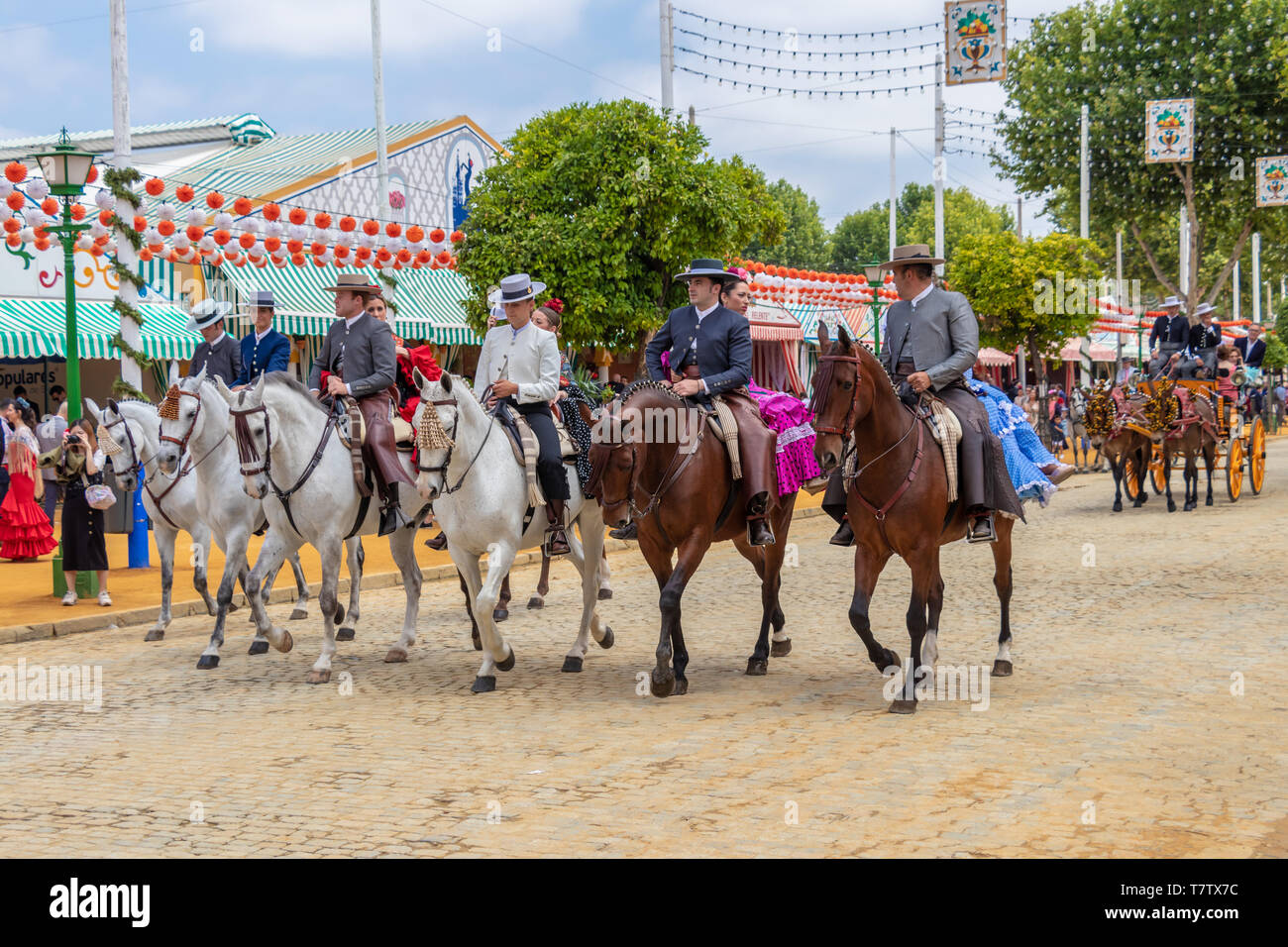 Seville, Spain - May 5, 2019: People riding horses and celebrating Seville's April Fair, Seville Fair (Feria de Sevilla). The Seville April Fair on Ma Stock Photo