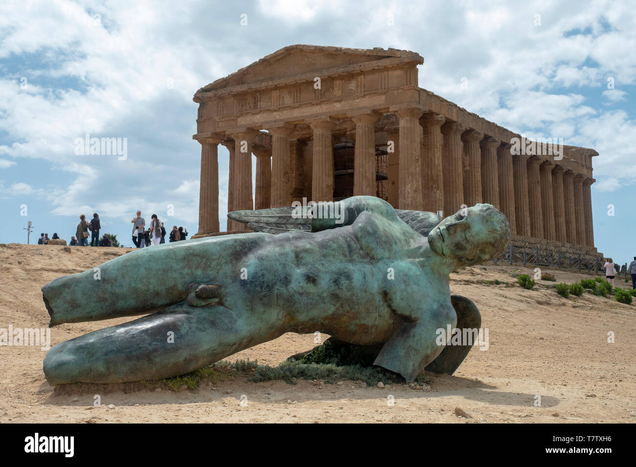 Temple of Concordia & Fallen Ikarus sculpture by Igor Mitoraj, Valley of the Temples, Agrigento. Sicily. Italy Stock Photo