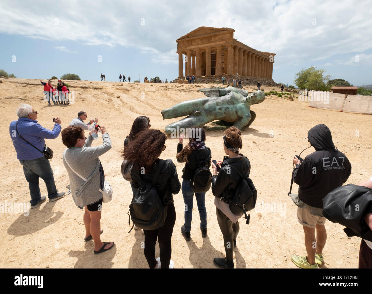 Temple of Concordia & Fallen Ikarus sculpture by Igor Mitoraj, Valley of the Temples, Agrigento. Sicily. Italy Stock Photo