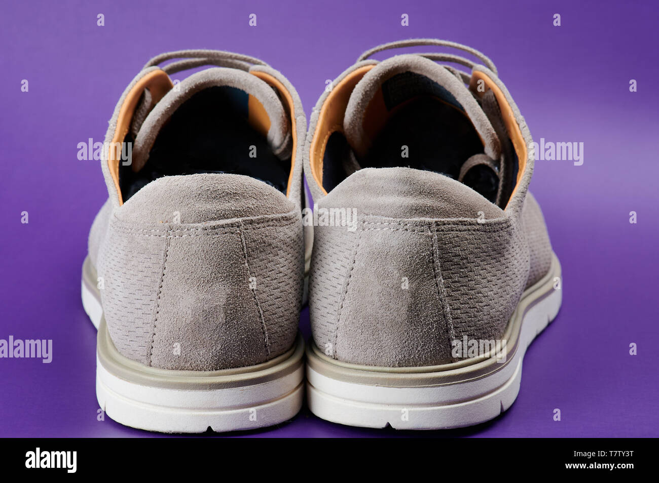 Back view of gray man shoes isolated on purple background Stock Photo