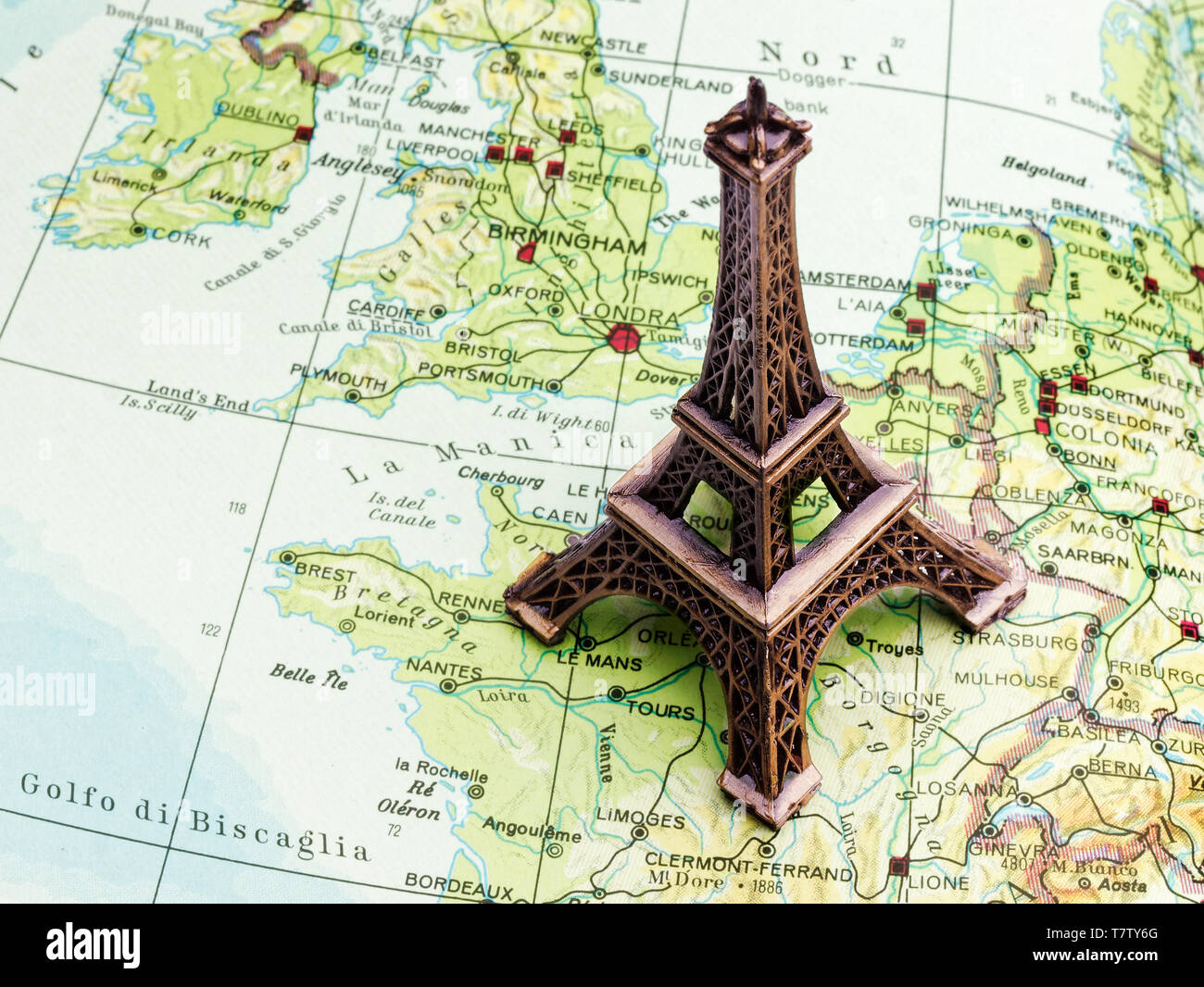 Small Eiffel tower Paris souvenir on map Stock Photo