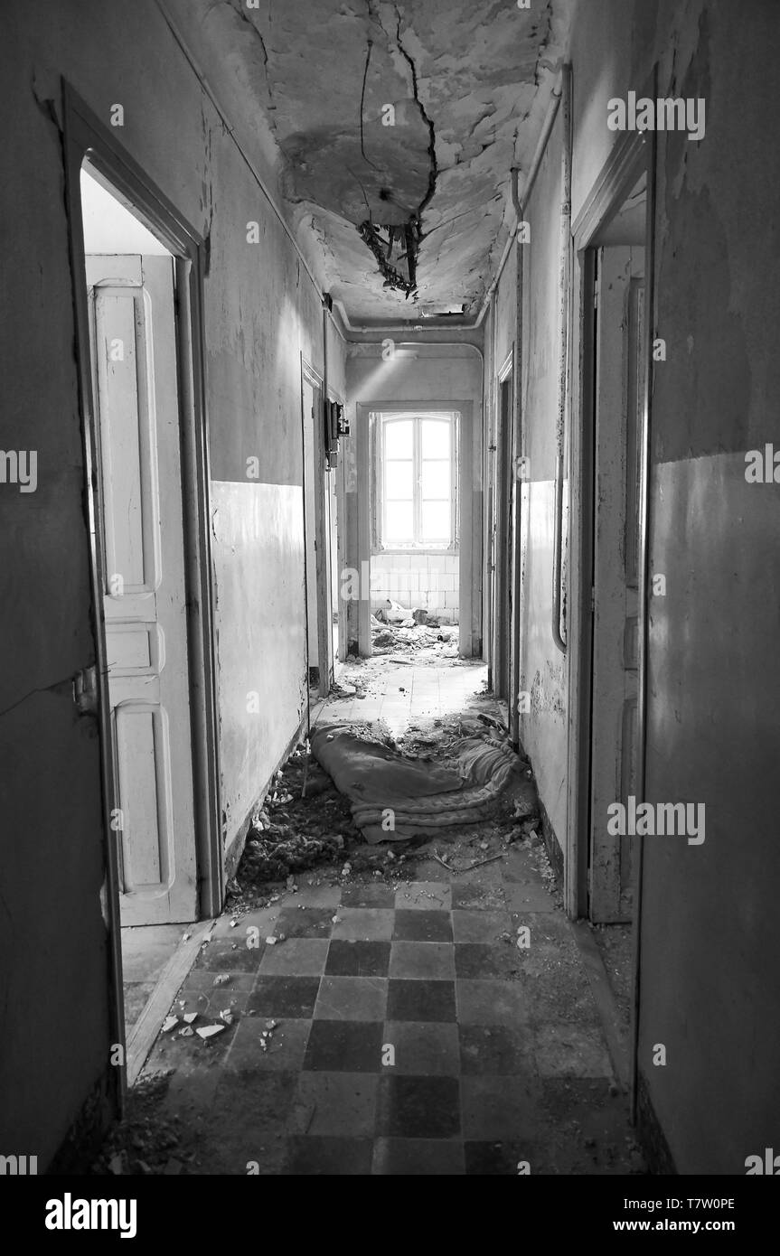 Interior corridor in ruined facilities at the abandoned Canfranc International railway station (Canfranc, Pyrenees, Huesca, Aragon, Spain).B&W version Stock Photo