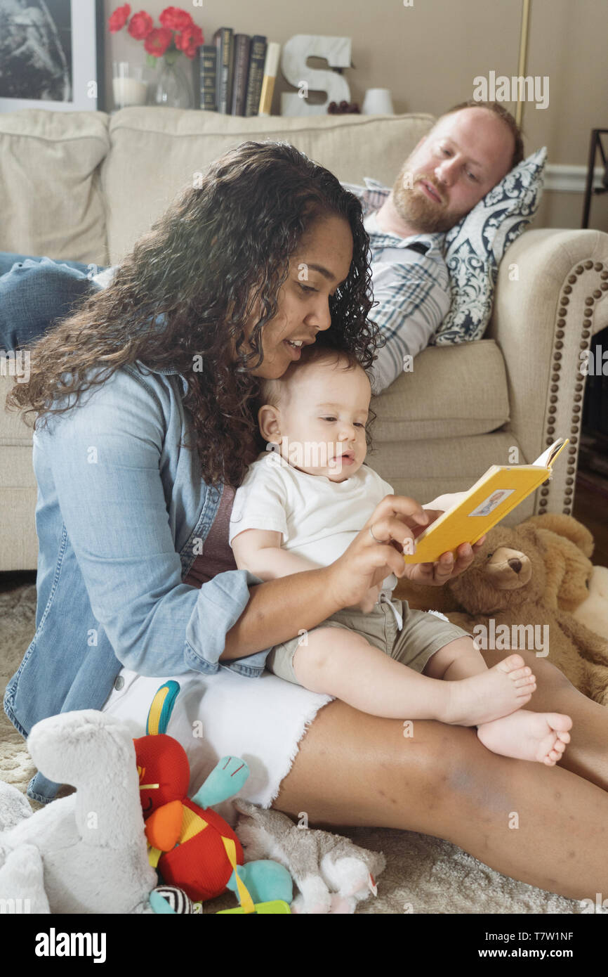 family of  4 in their home north Philadelphia, 6 month old baby, 15 year old sister. Stock Photo