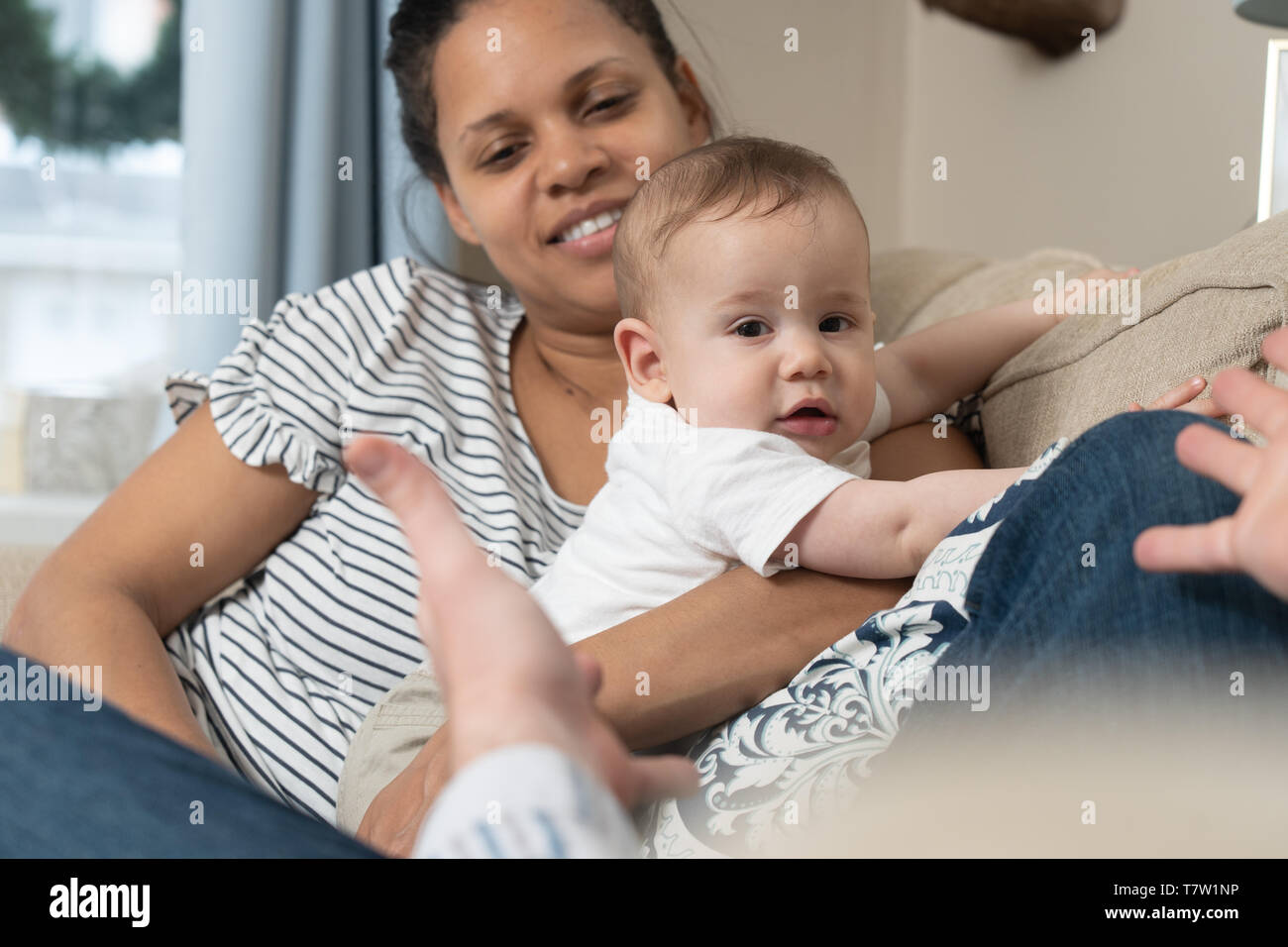 parents paly with her 6 month old baby in their home in northern Philadelphia Stock Photo