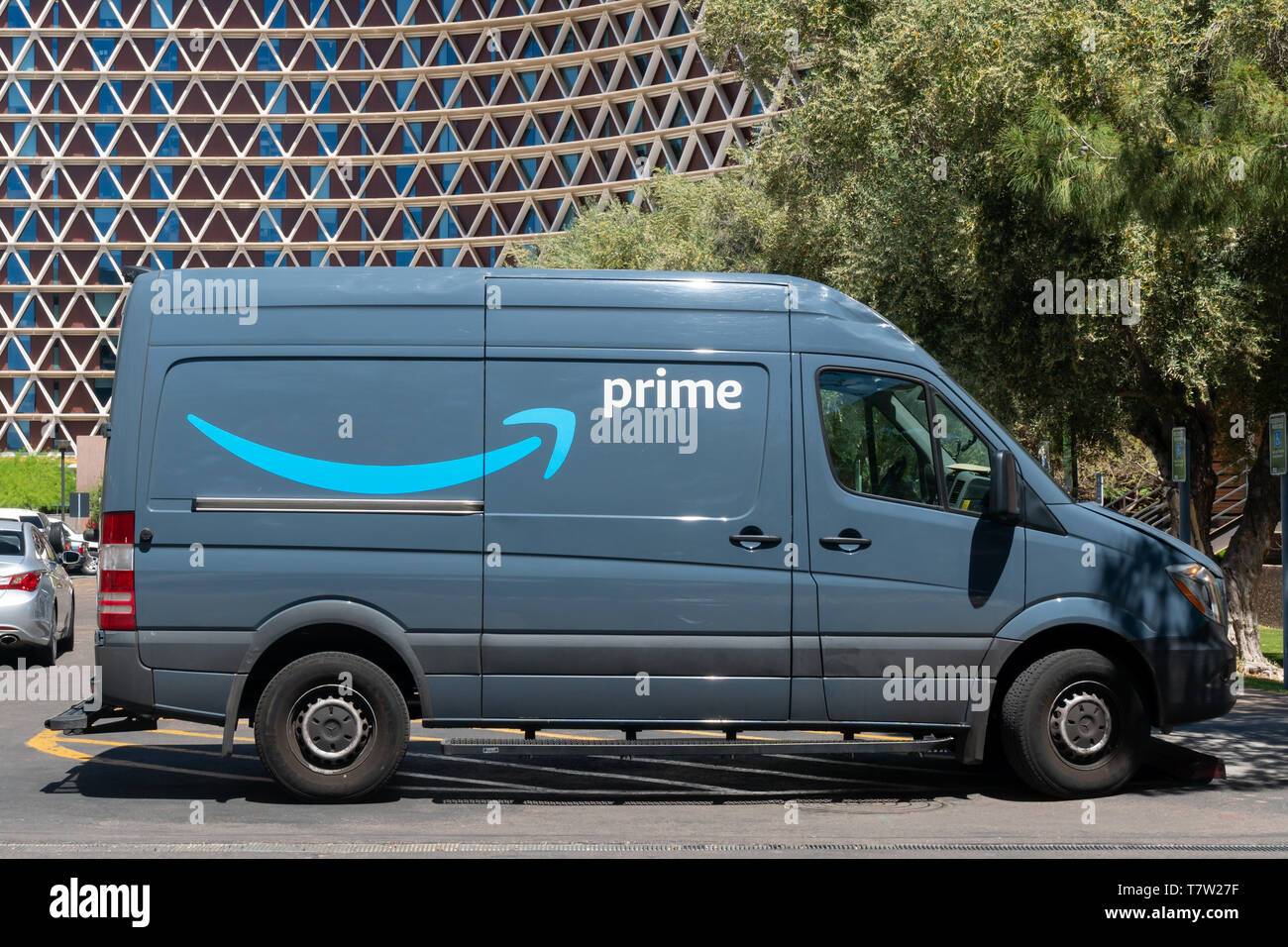 TEMPE, AZ/USA - APRIL 10, 2019: Amazon Prime delivery vehicle and trademark logo. Stock Photo