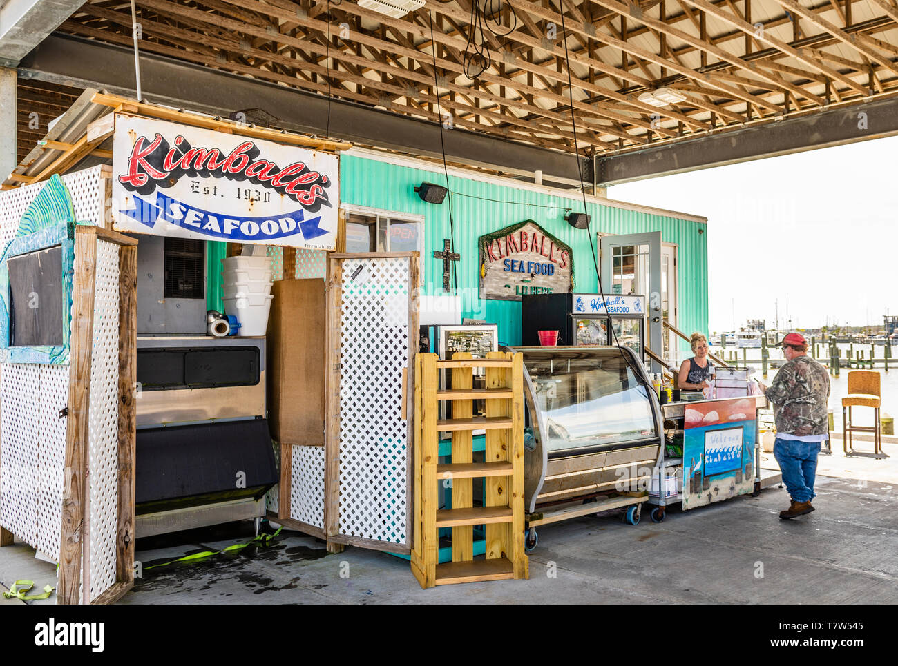Fresh gulf coast shrimp and seafood market vendor selling fish at the