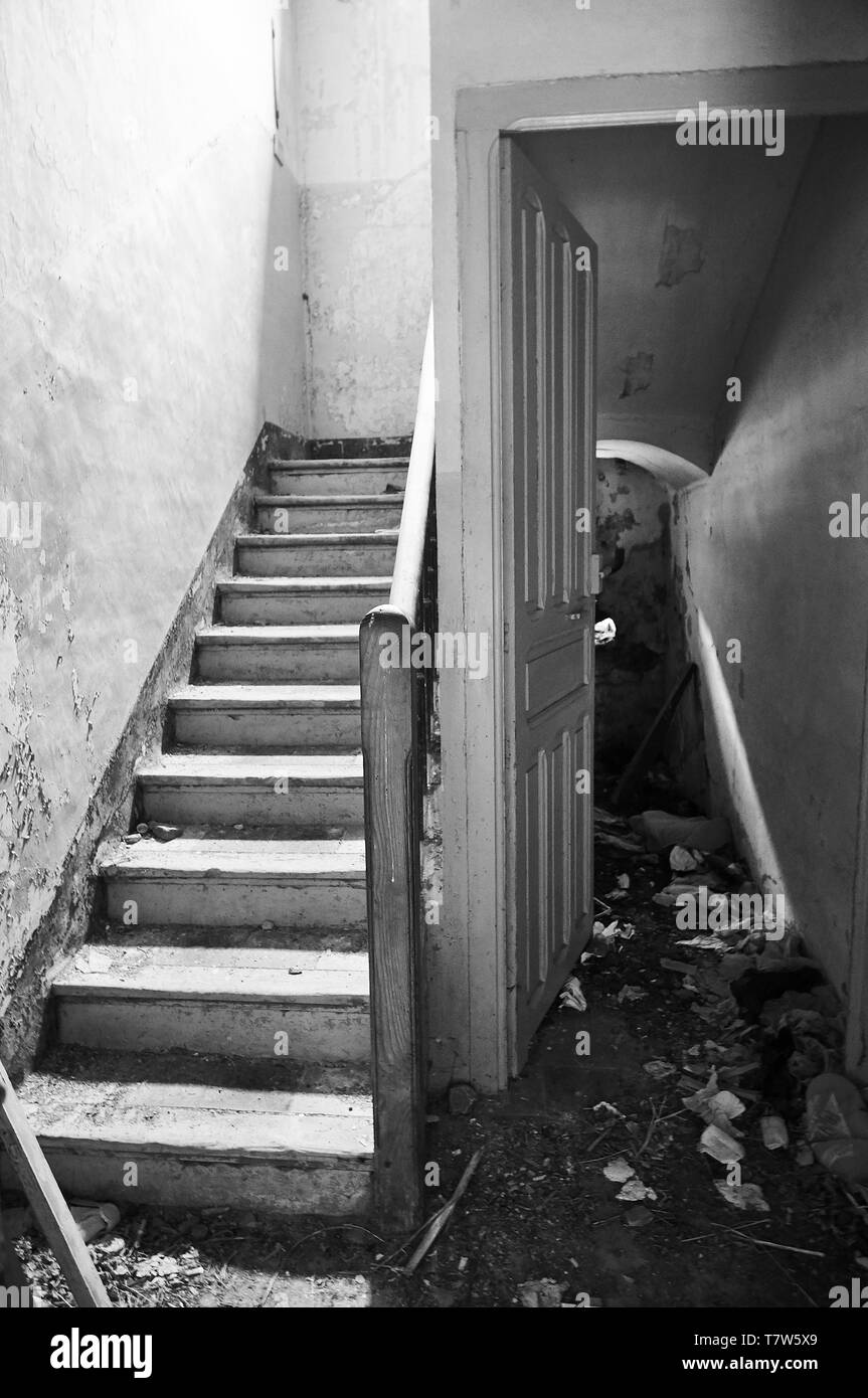 Interior stairs in ruined facilities at the abandoned Canfranc International railway station (Canfranc, Pyrenees, Huesca, Aragon, Spain). B&W version Stock Photo
