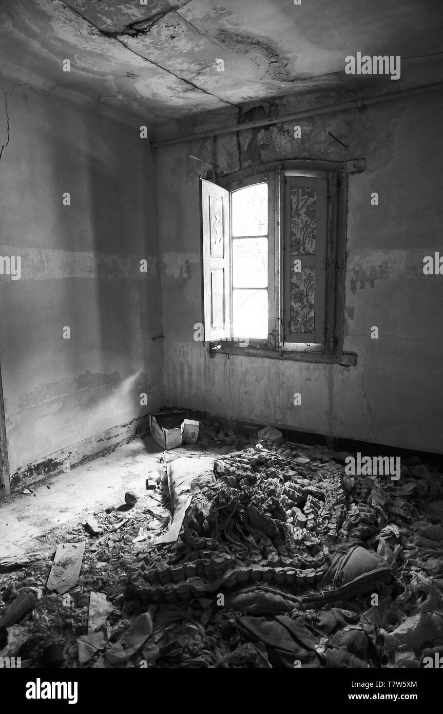 Interior of a room in ruined facilities at the abandoned Canfranc International railway station (Canfranc,Pyrenees,Huesca,Aragon,Spain). B&W version Stock Photo