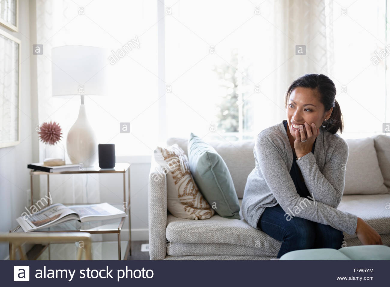 Woman happy sofa sitting hi-res stock photography and images - Alamy