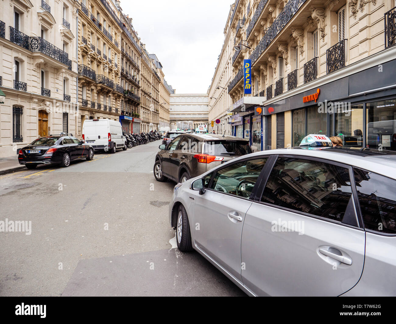 Paris, France - Jan 1, 2018: cars parked on Rue de Maubeuge near Gare de Nord train station with Monoprix supermarket in background - perspective view Stock Photo