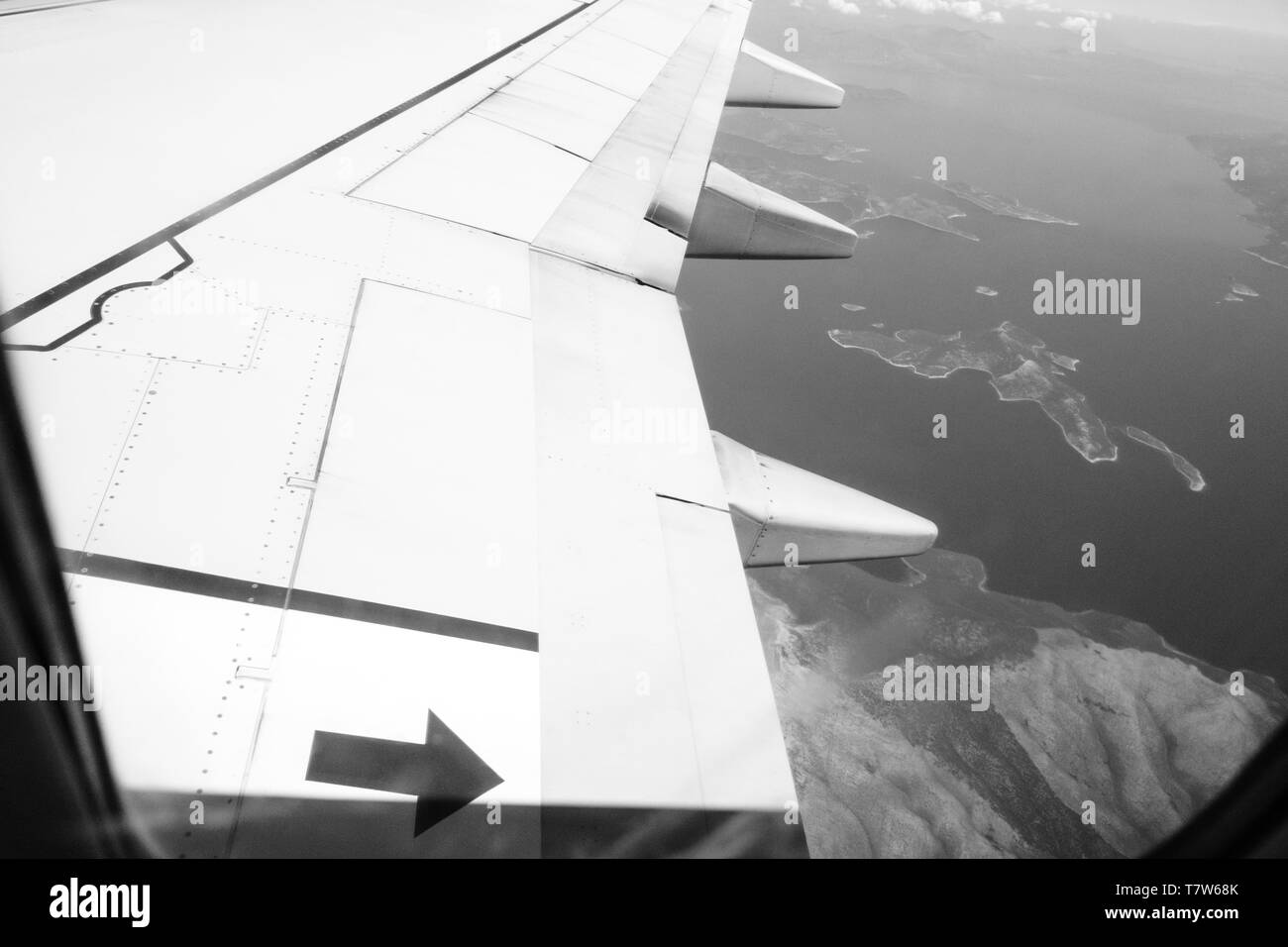 View from the plane at Greek archipelago with islands and Mediterranean sea - black and white Stock Photo