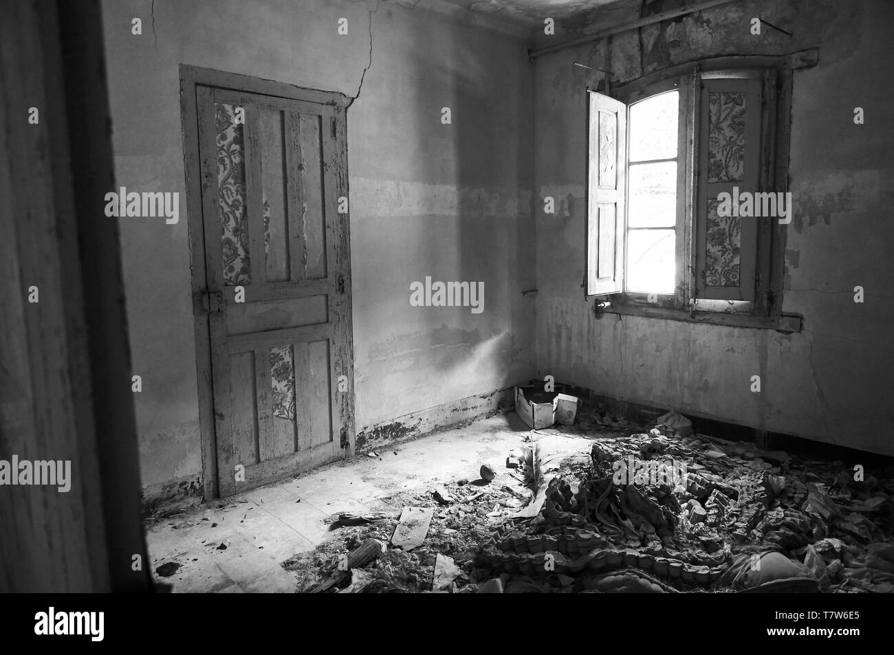 Interior of a room in ruined facilities at the abandoned Canfranc International railway station (Canfranc,Pyrenees,Huesca,Aragon,Spain). B&W version Stock Photo