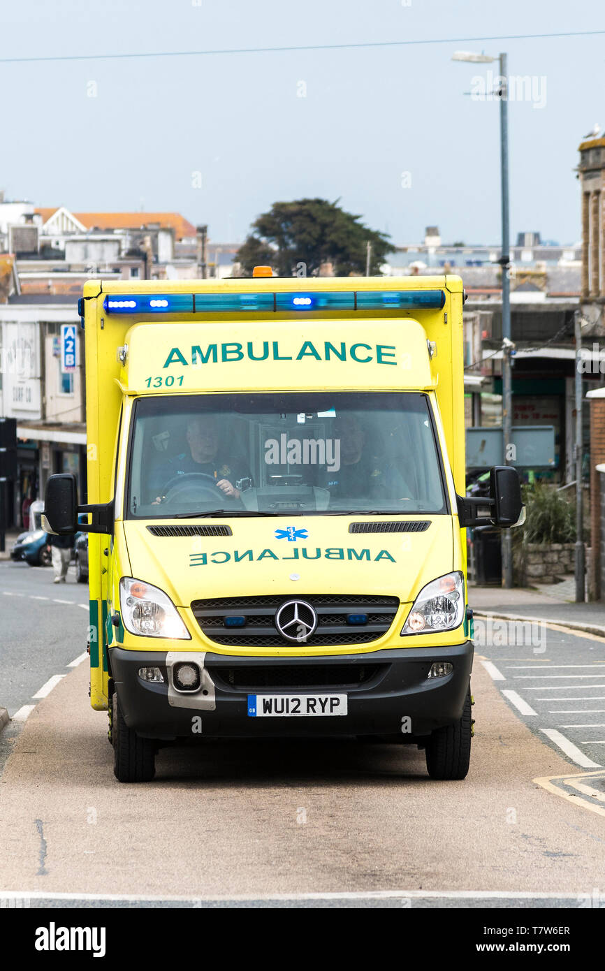 An ambulance with blue lights on reponding to an emergency call in