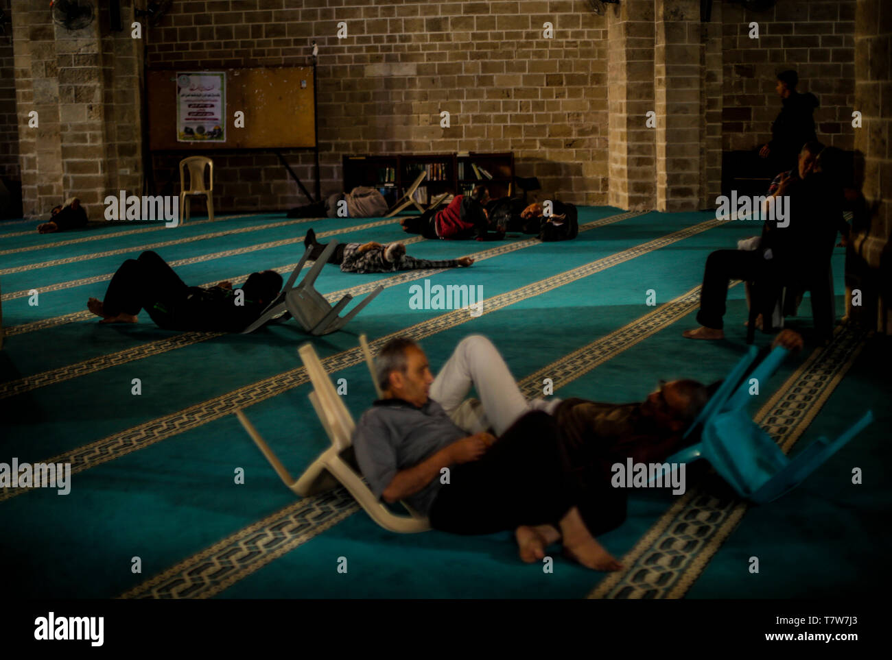 Palestinians seen relaxing at the al-Omari mosque during Ramadan. Third day of Ramadan. Muslims throughout the world are participating in the holy fasting month of Ramadan, the holiest month in Islamic calendar, refraining from eating, drinking and smoking from dawn to dusk. Stock Photo