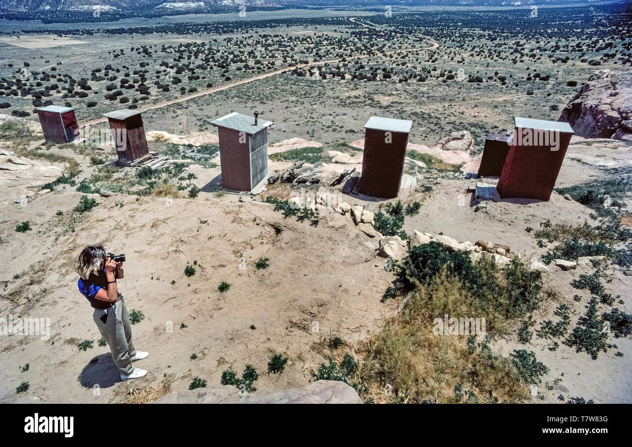 Homemade wooden outhouses line the edge of a sandstone mesa that is home to the Acoma Pueblo, a Native American community of four indian villages in an isolated area some 60 miles (97 km) west of Albuquerque, the capital of New Mexico in southwestern USA. Founded in the 12th Century, Acoma is the oldest continuously inhabited settlement in North America. Some 30 tribal members live on the mesa in adobe dwellings that have no sewage disposal, electricity or running water. Tourists are welcome to join guided tours of the historic Sky City (Old Acoma) village. Stock Photo