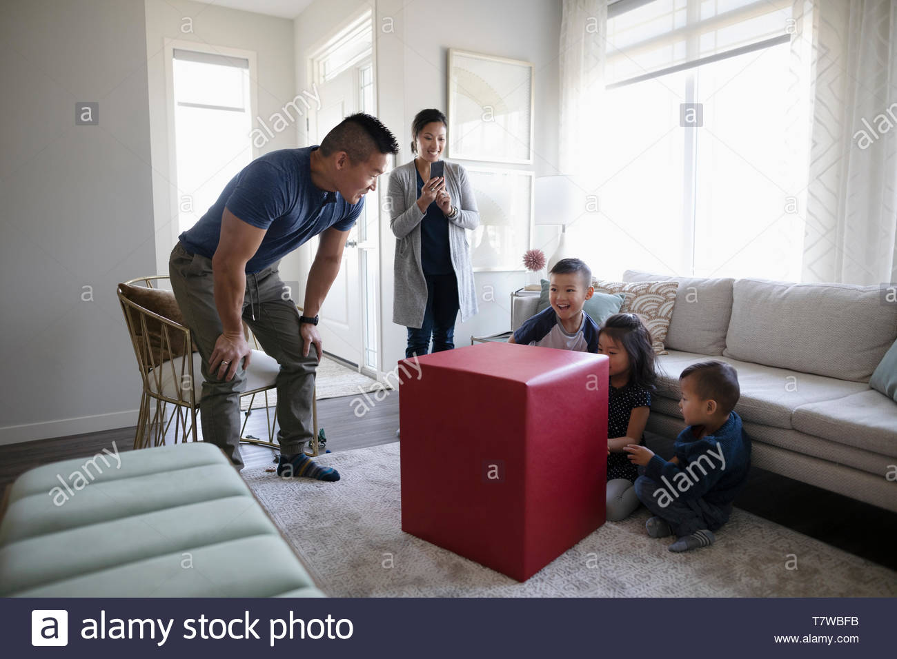 Father surprising children with large gift Stock Photo