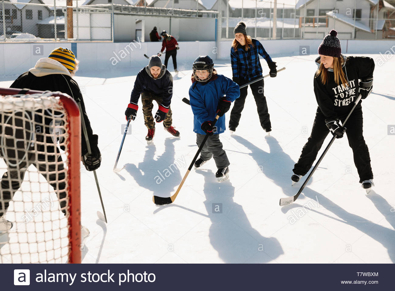 Community playing outdoor ice hockey Stock Photo Alamy