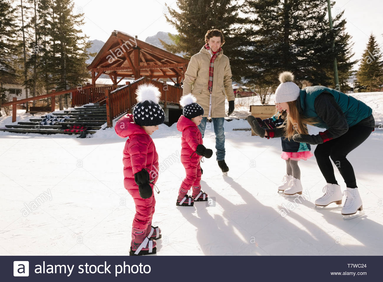 Family ice skating on frozen pond Stock Photo Alamy