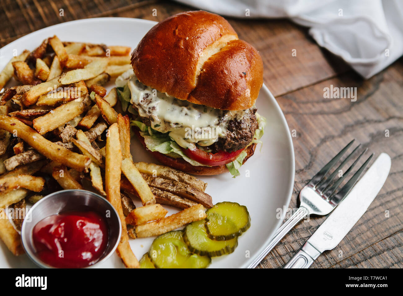 Shallot Tarragon Cheeseburger with french fries plated, restaurant ...