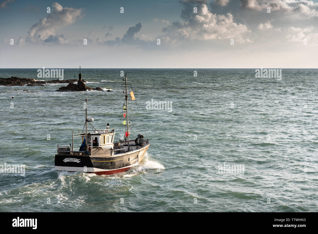Fishing boat leaving the port of Barfleur, France, Manche (50) Stock Photo