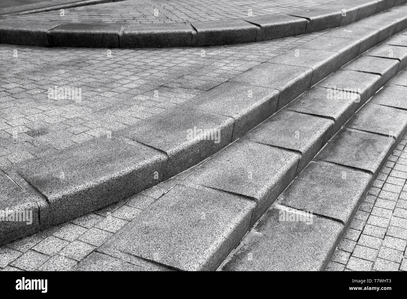 Abstract architectural fragment. Stairway made of dark gray granite stone Stock Photo