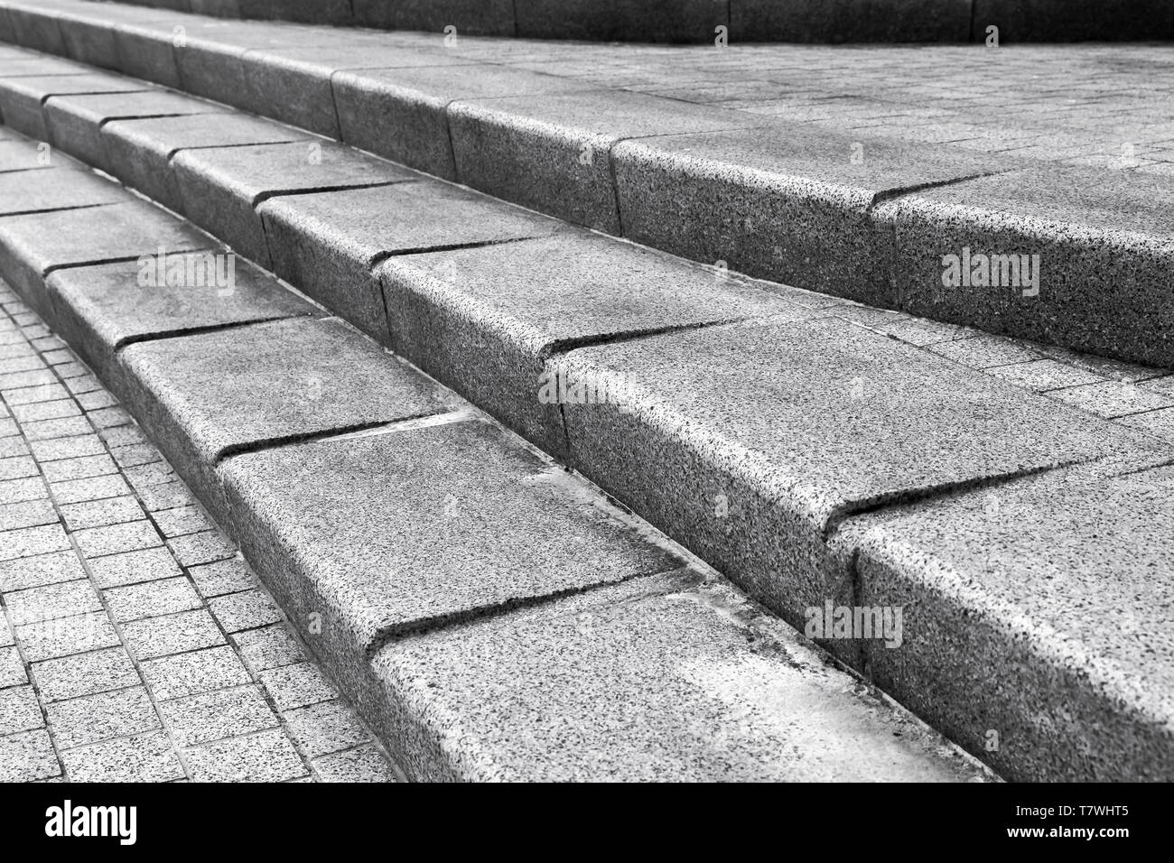 Abstract urban architectural fragment. Stairway made of dark gray granite stone Stock Photo