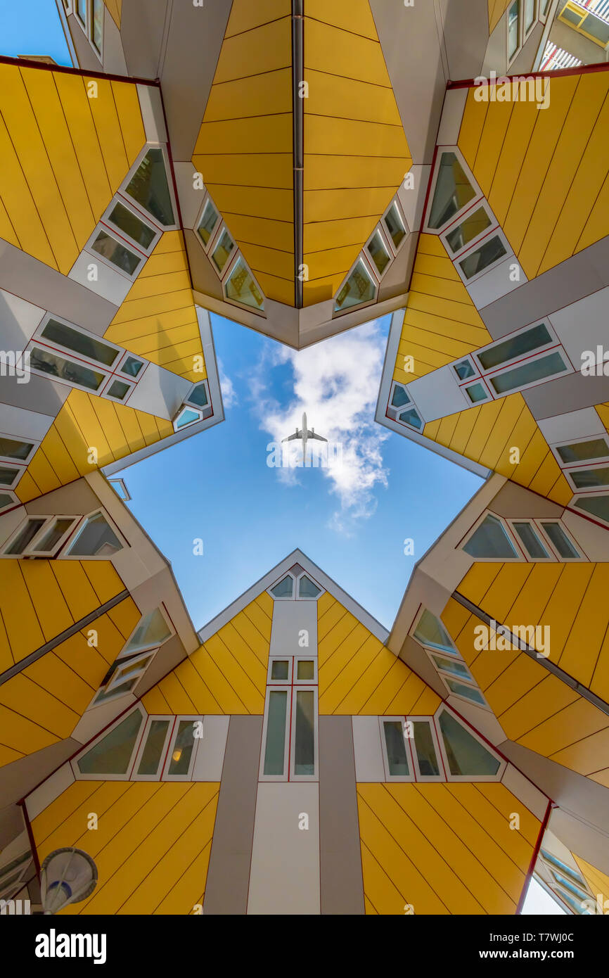 ROTTERDAM, 13 April 2019 - Plane flying over a 360 degrees up view of the yellow cubic houses inner court showing the rectangular faces of the houses Stock Photo
