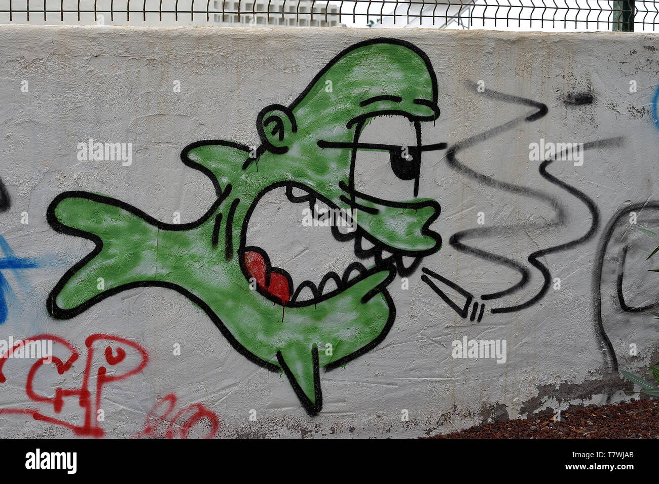 Graffiti of a fish smoking a joint on a wall in Tenerife, Spain Stock