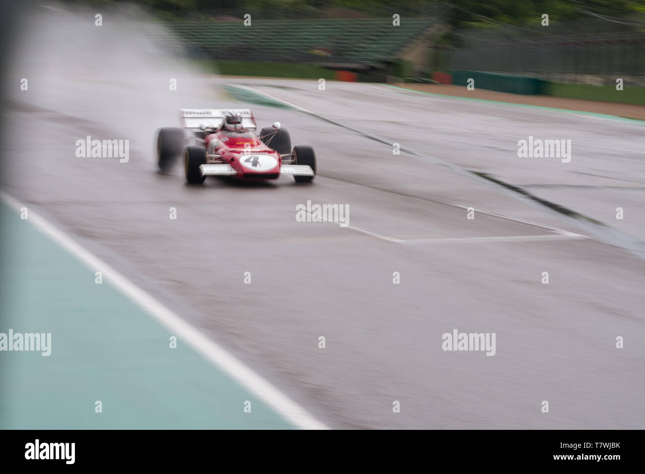 vintage formula one car is flying on a wet track, panning photo Stock Photo