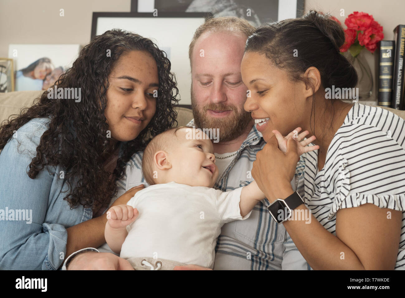 family of  4 in their home in north Philadelphia, 6 month old baby, 15 year old sister. Stock Photo