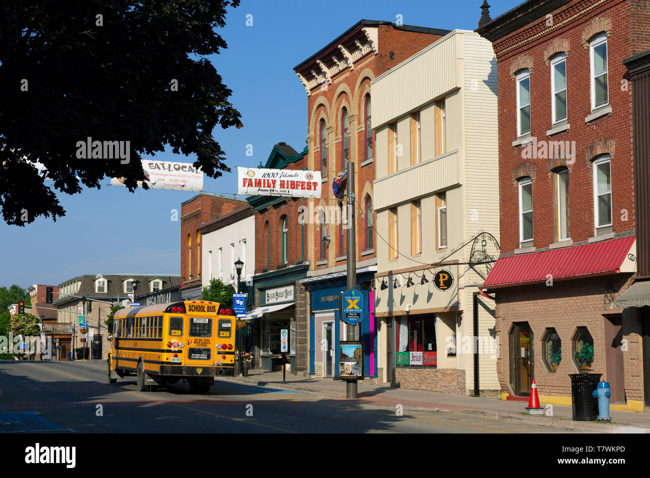 Canada, Province of Ontario, Gananoque, King Street, the main and shopping street of the city, yellow school bus Stock Photo