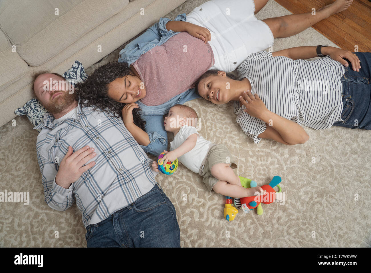 family of  4 in their home in north Philadelphia, 6 month old baby, 15 year old sister and parents. Stock Photo