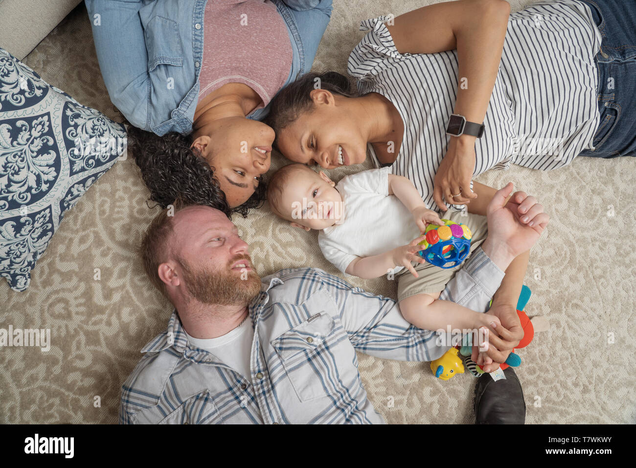 family of  4 in their home in north Philadelphia, 6 month old baby, 15 year old sister and parents. Stock Photo