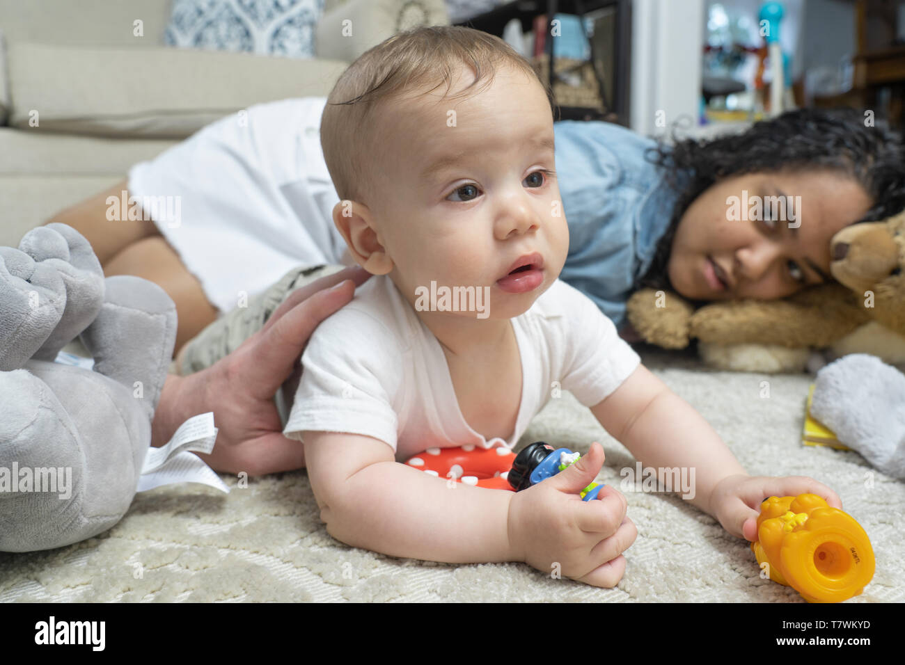 sister (15 years old) holds her baby brother (6 monthes old)  in her home in northern Philadelphia Stock Photo