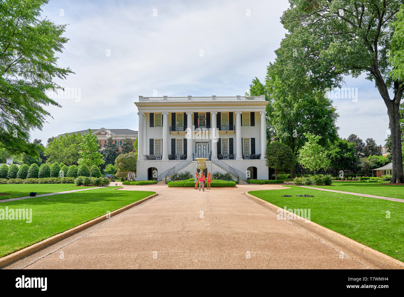 University of Alabama President's Mansion or house on the university campus with students posing for pictures, in Tuscaloosa Alabama, USA. Stock Photo