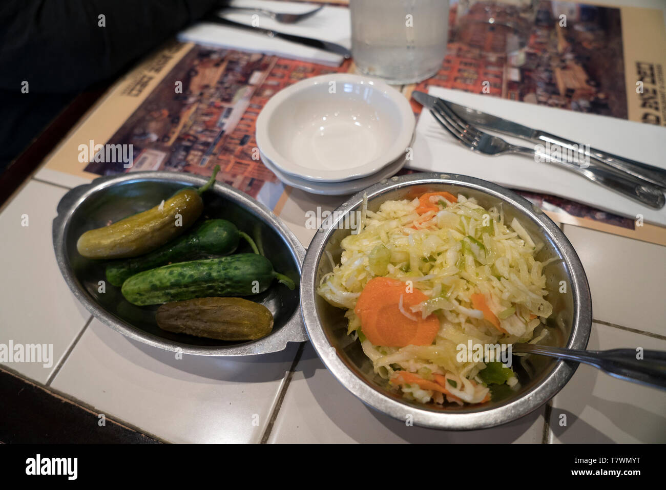 Cole slaw and pickles at the 2nd Avenue Deli on the Upper East Side of Manhattan. Stock Photo