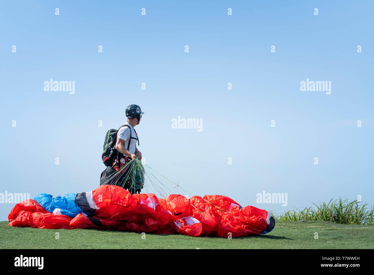 Son Tra Peninsula, Da Nang city, Vietnam - April 27, 2019: Athletes are preparing before flying paragliding on top of Son Tra Mountain. Stock Photo
