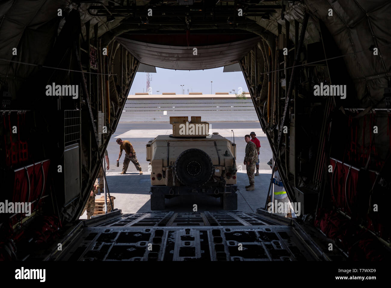 U.S. Soldiers assigned to the East Africa Response Force (EARF), Combined Joint Task Force-Horn of Africa, back a HMMWV onto a C-130J Hercules assigned to the 75th Expeditionary Airlift Squadron during an emergency deployment response exercise at Camp Lemonnier, Djibouti, May 1, 2019. The EARF provides a broad range of rapidly deployable military capabilities to protect American interests on the African continent should any threat arise. (U.S. Air Force photo by Tech. Sgt. Thomas Grimes) Stock Photo