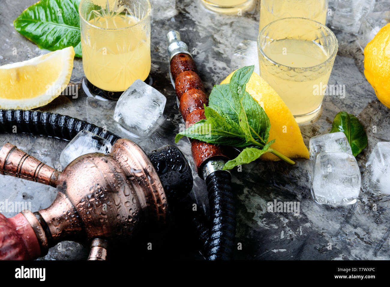 Smoking shisha and glasses with alcoholic limoncello.Hookah and alcohol