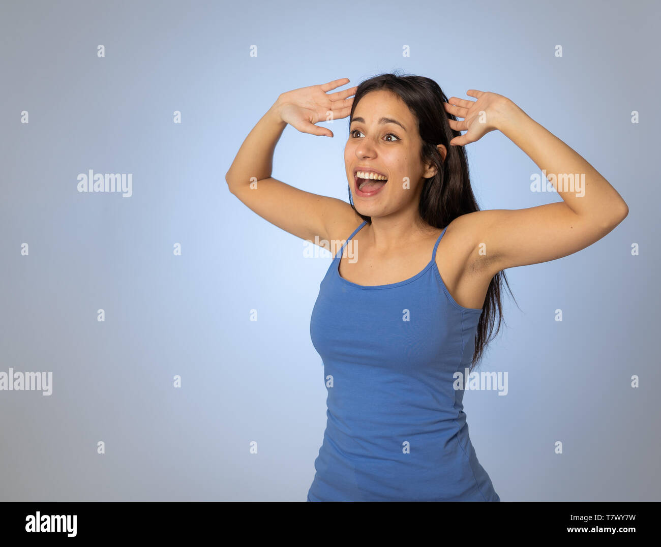 Portrait of beautiful shocked young latin woman surprised hearing good ...