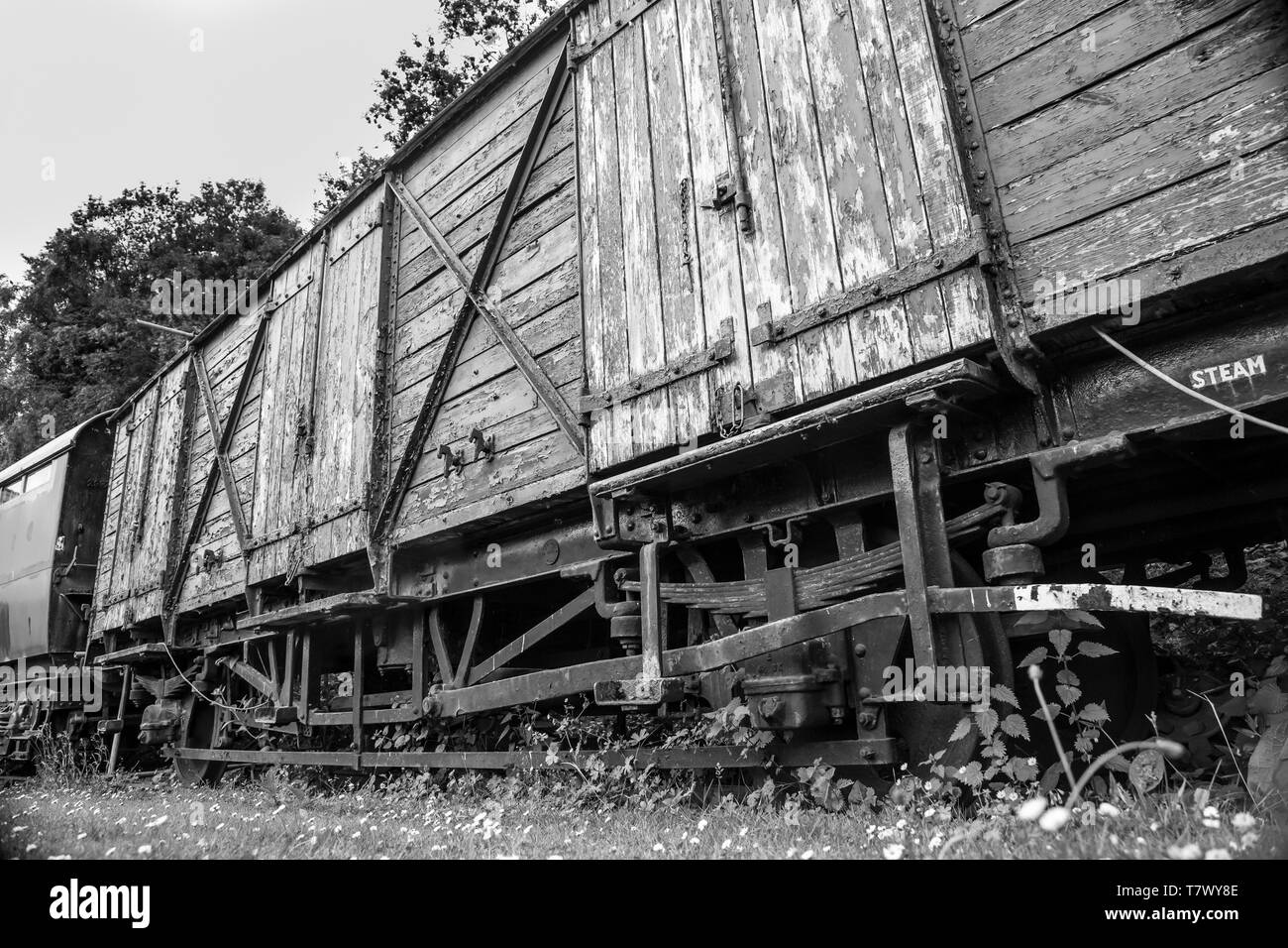 Black & white close up of disused, old, vintage railway carriage used for transportation of freight. Stock Photo