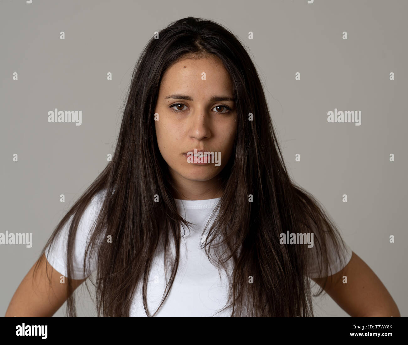 Close up of young attractive frustrated latin woman in stress with furious face. Looking mad and disappointed making angry gestures. In neutral backgr Stock Photo