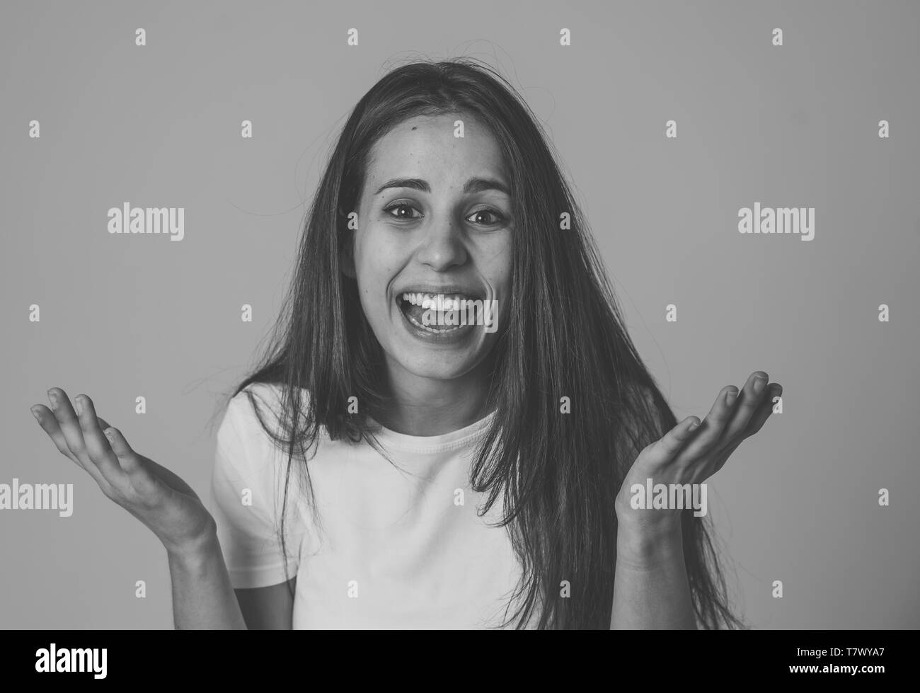 Portrait of beautiful shocked woman hearing good news or having great success with surprised and happy face. Making cheerful gestures. Facial Expressi Stock Photo