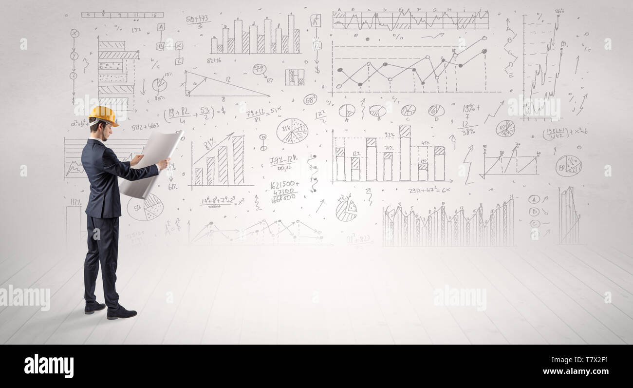 Engineer with construction helmet holding a plan and standing with ...