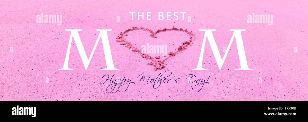 Pink Happy Mothers Day greeting card with text and heart drawing in beach sand texture background. Stock Photo