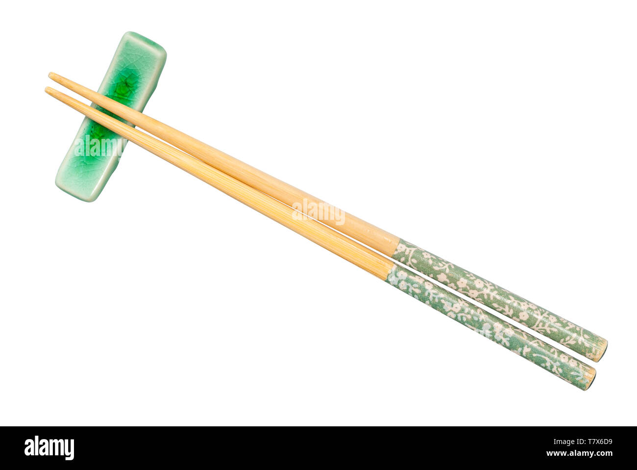 top view of decorated wooden chopsticks served on chopstick rest isolated on white background Stock Photo