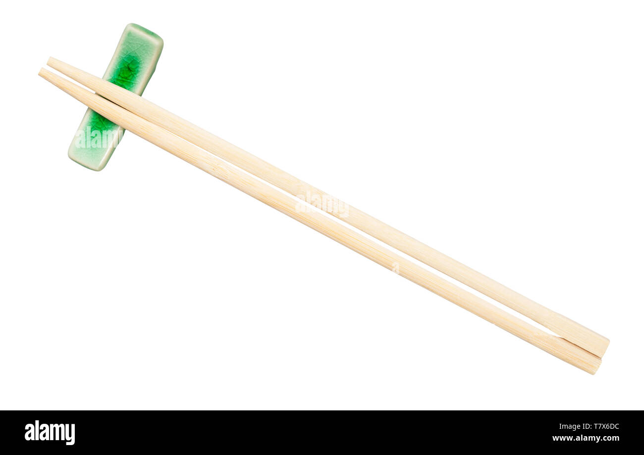top view of disposable wooden chopsticks served on chopstick rest isolated on white background Stock Photo
