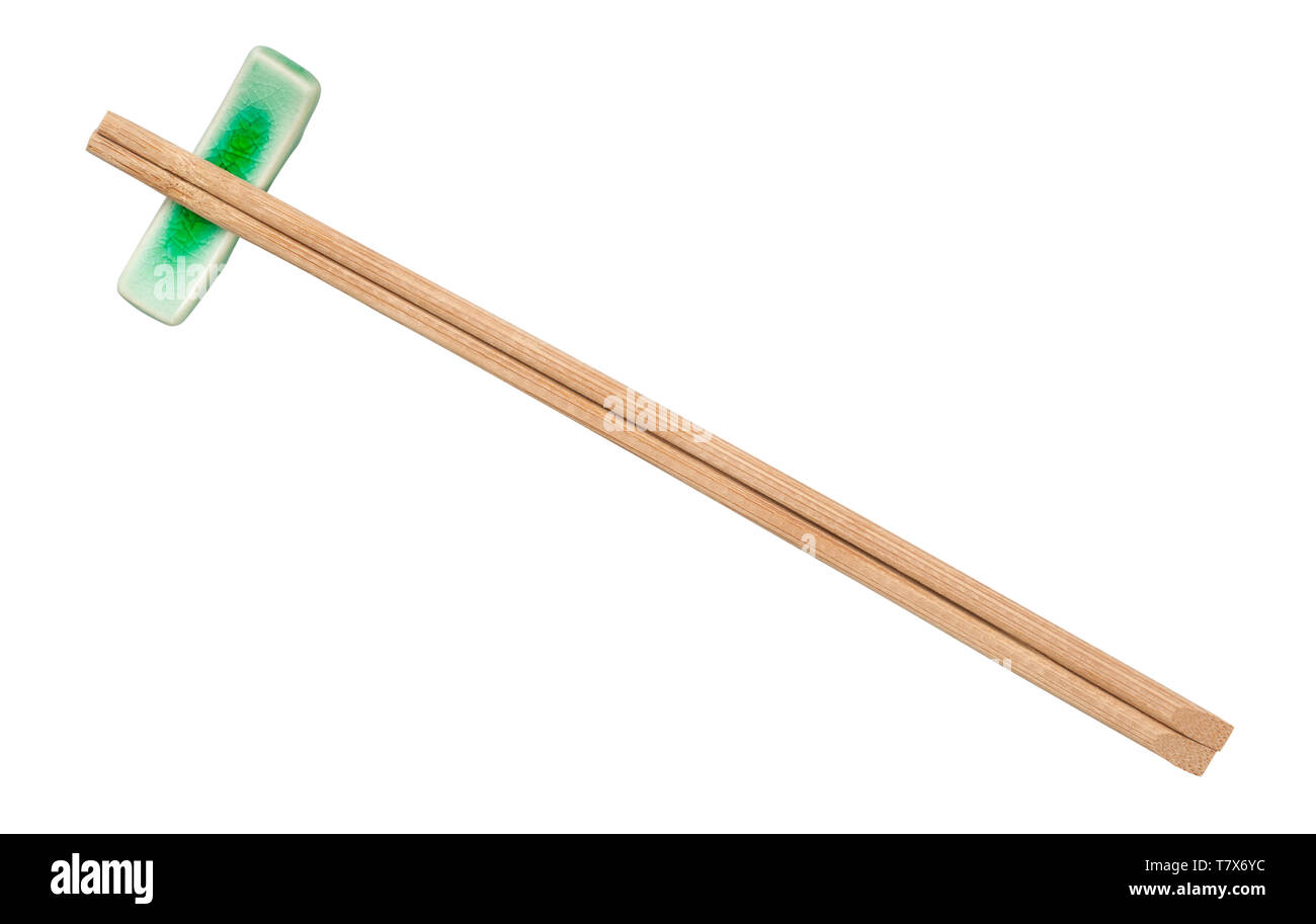 top view of brown wooden chopsticks served on chopstick rest isolated on white background Stock Photo
