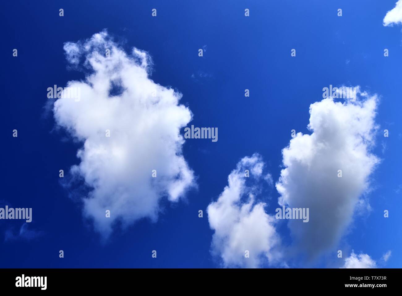 Beautiful white fluffy clouds on a deep blue sky in high resolution ...