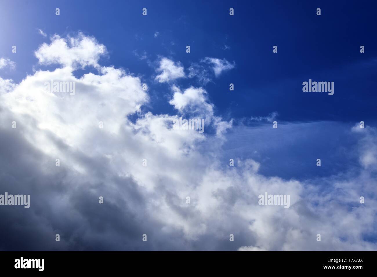 Beautiful white fluffy clouds on a deep blue sky in high resolution ...